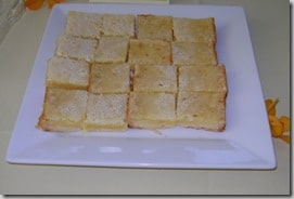 a square white plate of lemon bars