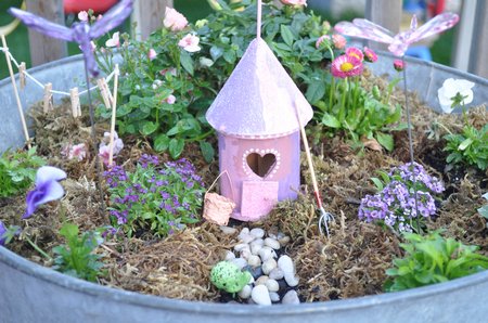 How To Make a Fairy Garden: See how to make fairy houses out of birdhouses and decorate with small plant, moss, a mini clothes line and items from the miniature store.