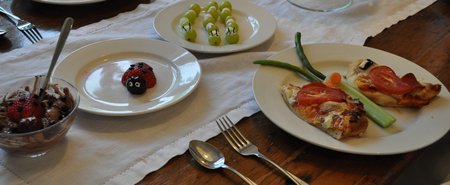 Bug Themed Party Food: pizza butterflies, dirt pudding, strawberry ladybugs, and grape caterpillars create an insect inspired dinner.