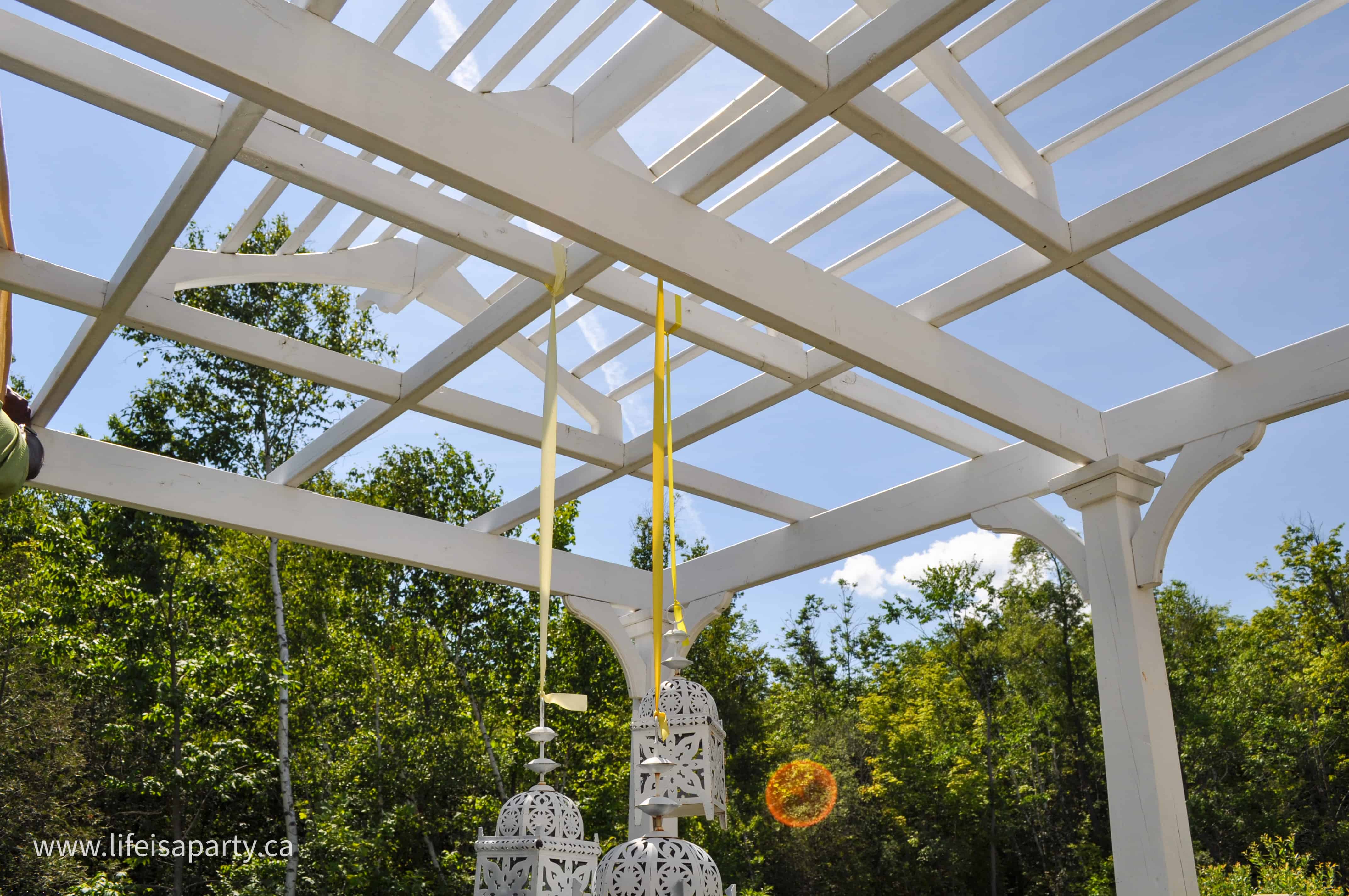 DIY Pergola Shade Cover: create shade under your pergola with these DIY fabric covers. These inexpensive covers are made from drop cloths and brass grommets and woven through the top of the pergola.