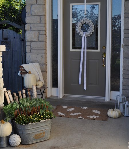fall front porch decorated with white