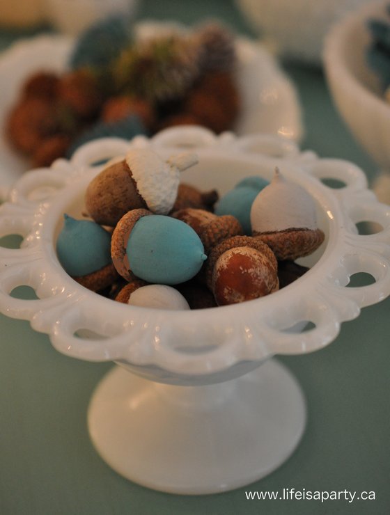 painted acorns in milk glass container