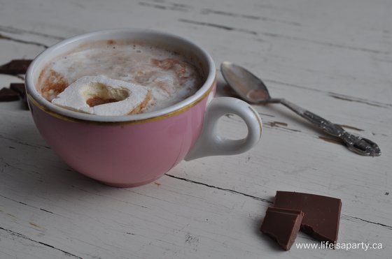pink mug of hot chocolate and vintage teaspoon