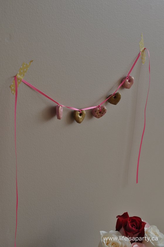 salt dough hearts in pink and gold made into to a banner