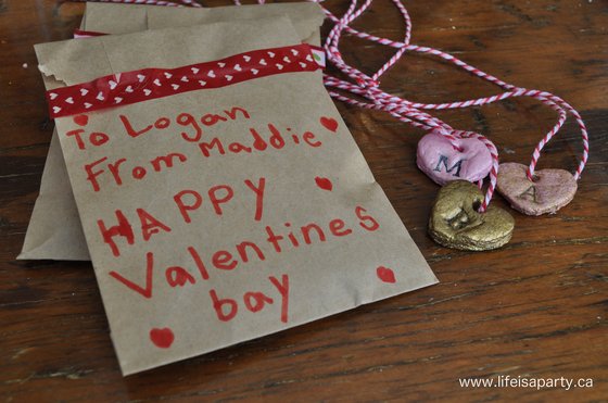 salt dough valentine necklaces packed in paper bags for school valentine exchange