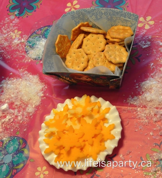 Snowflake crackers, with cheese cut out in snowflake shapes with a cookie cutter.