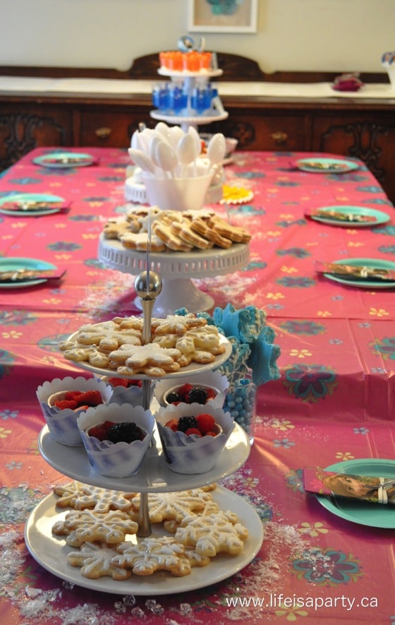 Frozen party table with trays of themed food.