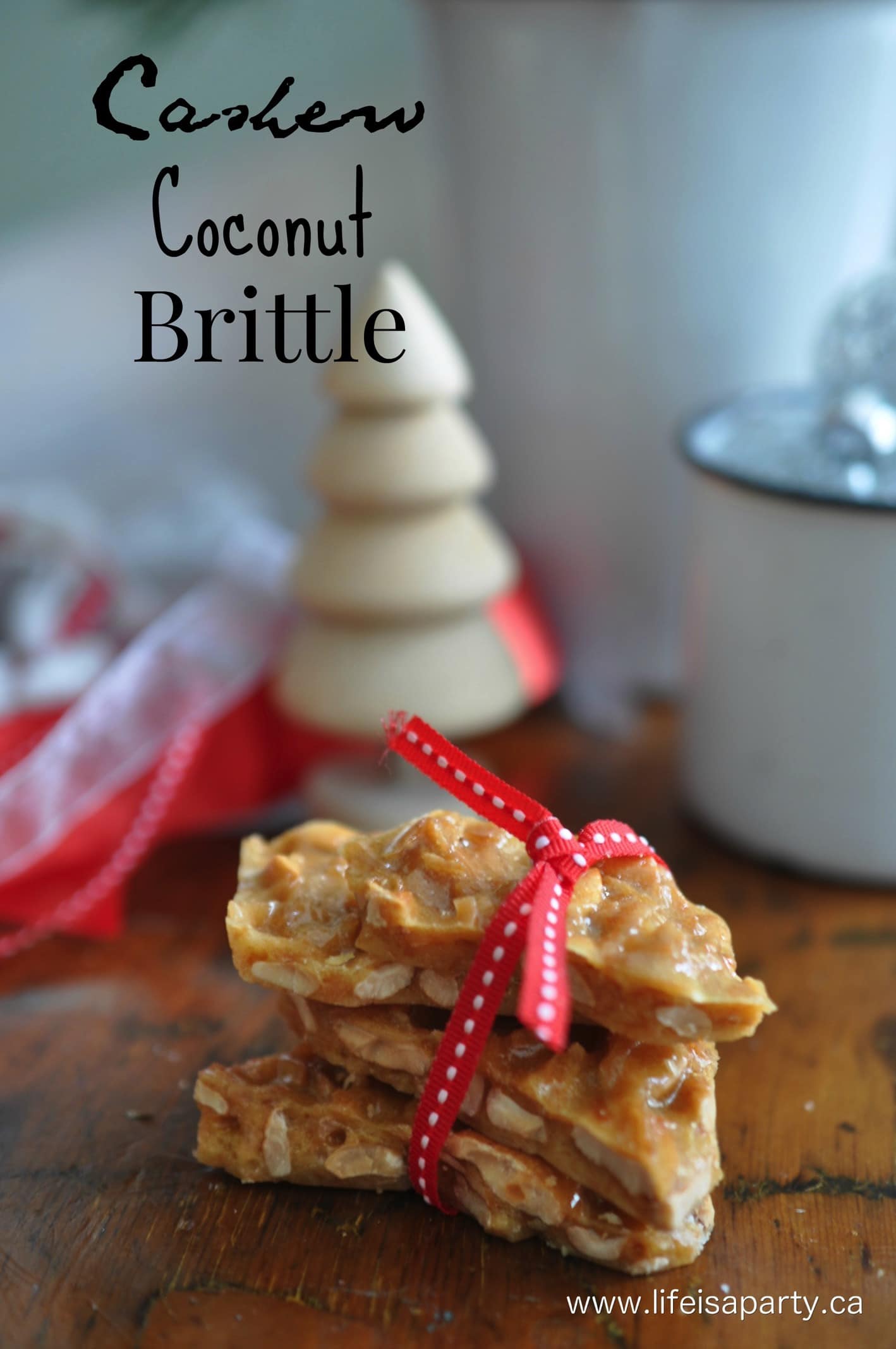 cashew coconut brittle pieces stacked up and tied with red ribbon