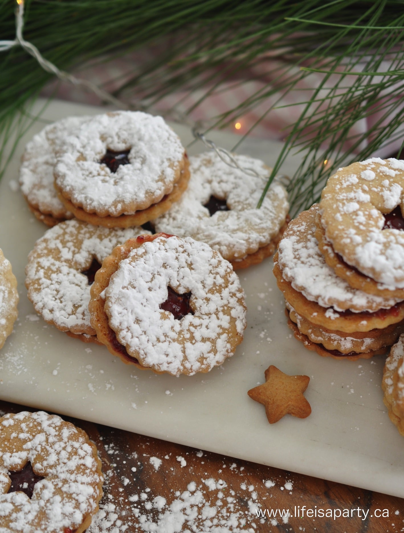 jam jam cookies with star centre cutouts and sprinkled with powdered sugar