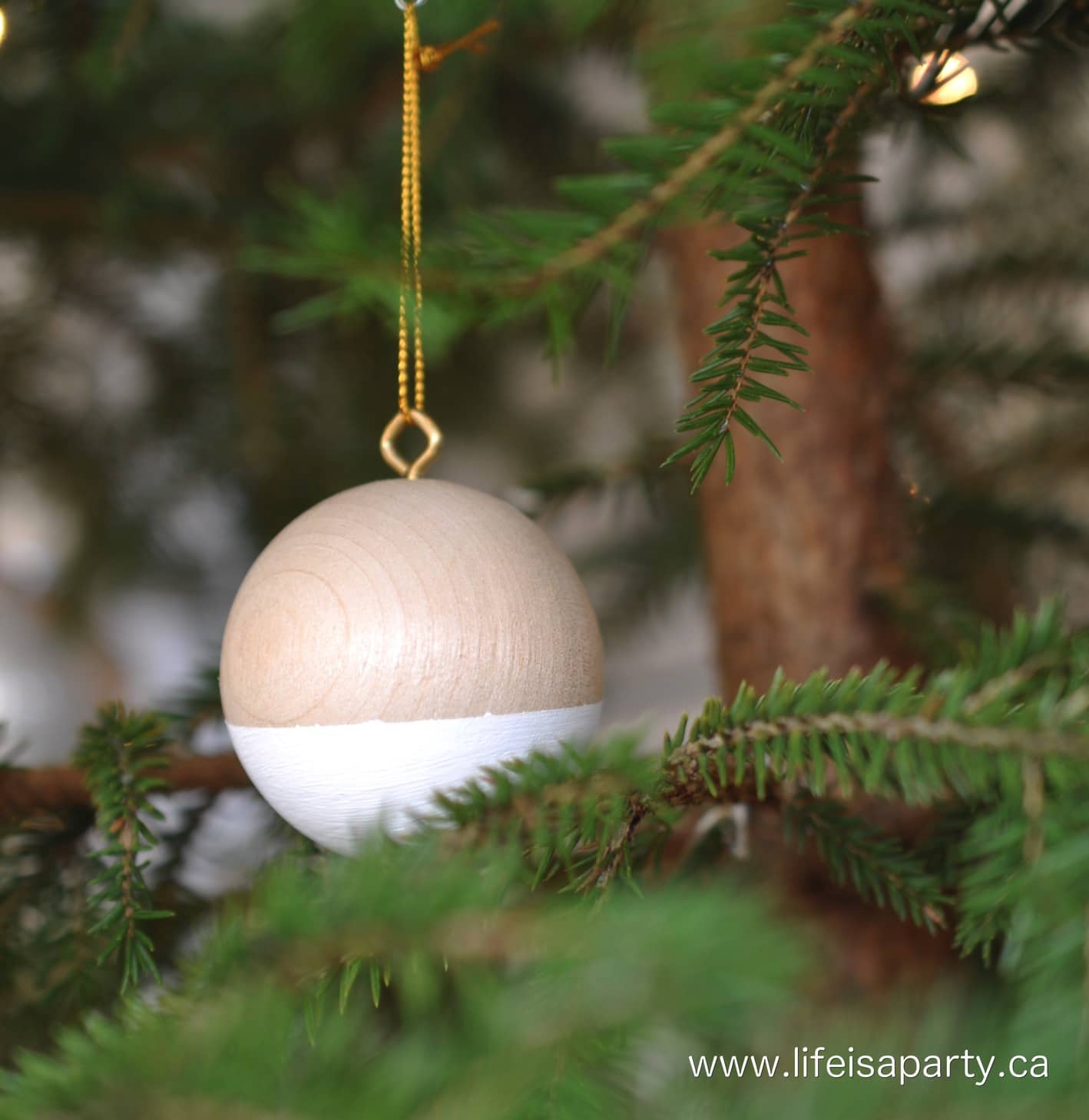 wood Christmas ornament hanging in Christmas tree