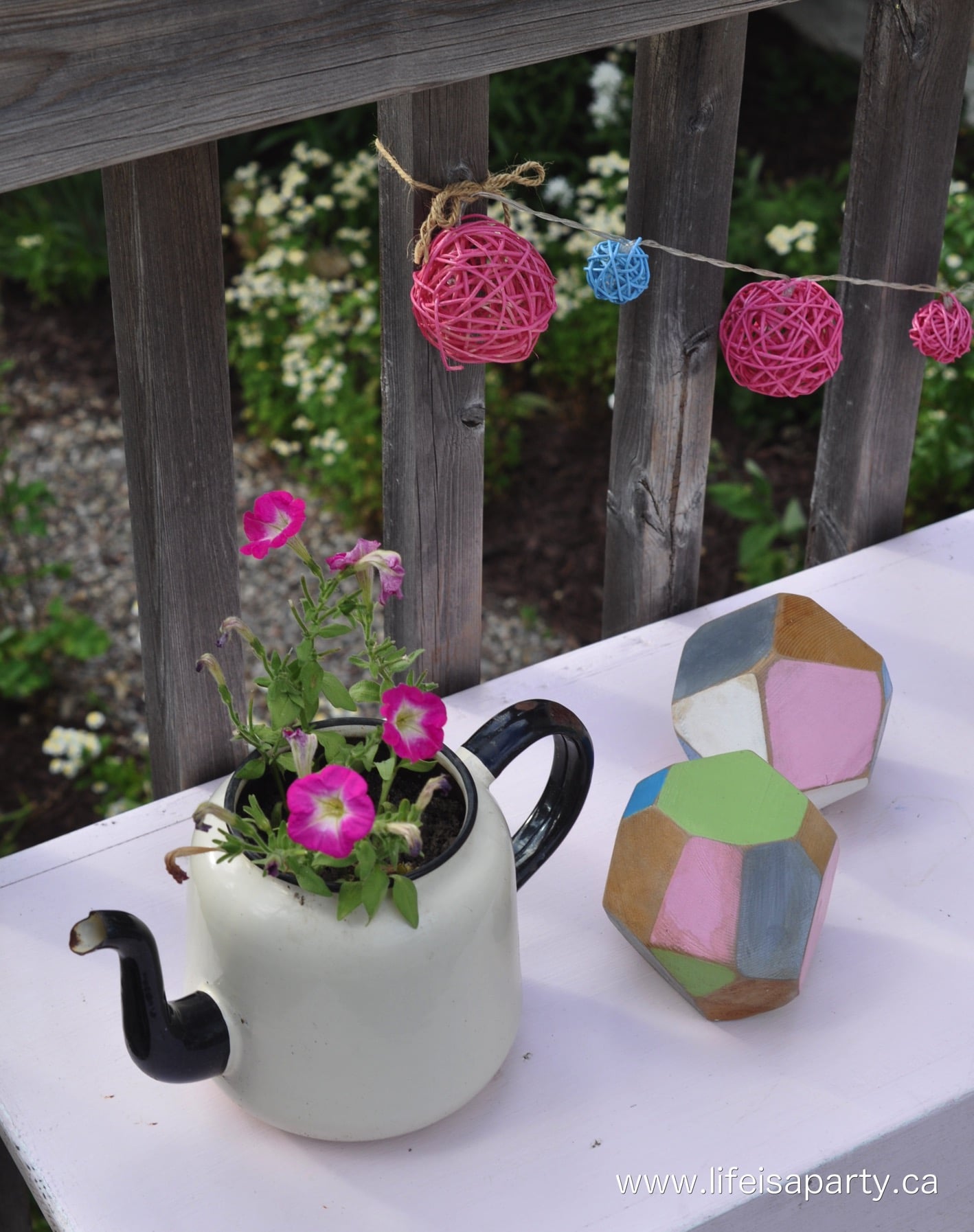 flowers planted in an old teapot