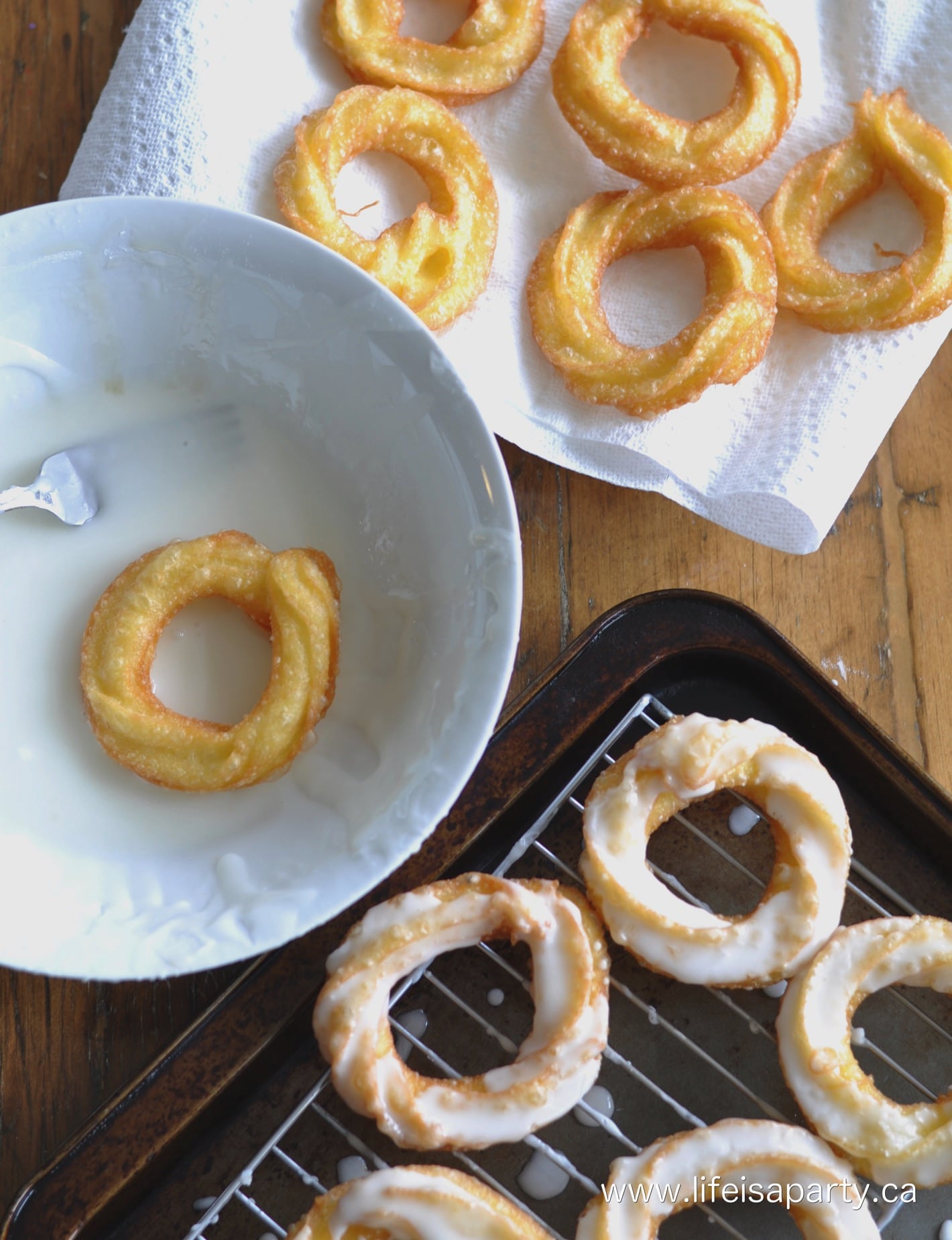 Homemade Honey Cruller Donuts that have just been fried, and dipped in glaze