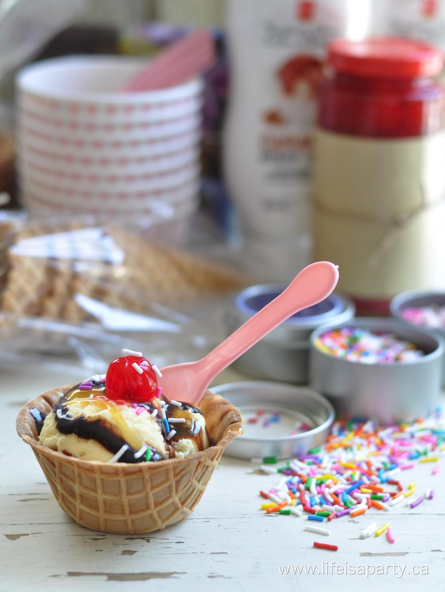 Ice Cream Sundae Kit: Perfect for summer gift giving. Wrap up your favourite ice cream toppings, sauces, cherries, ice cream cones, and ice cream.