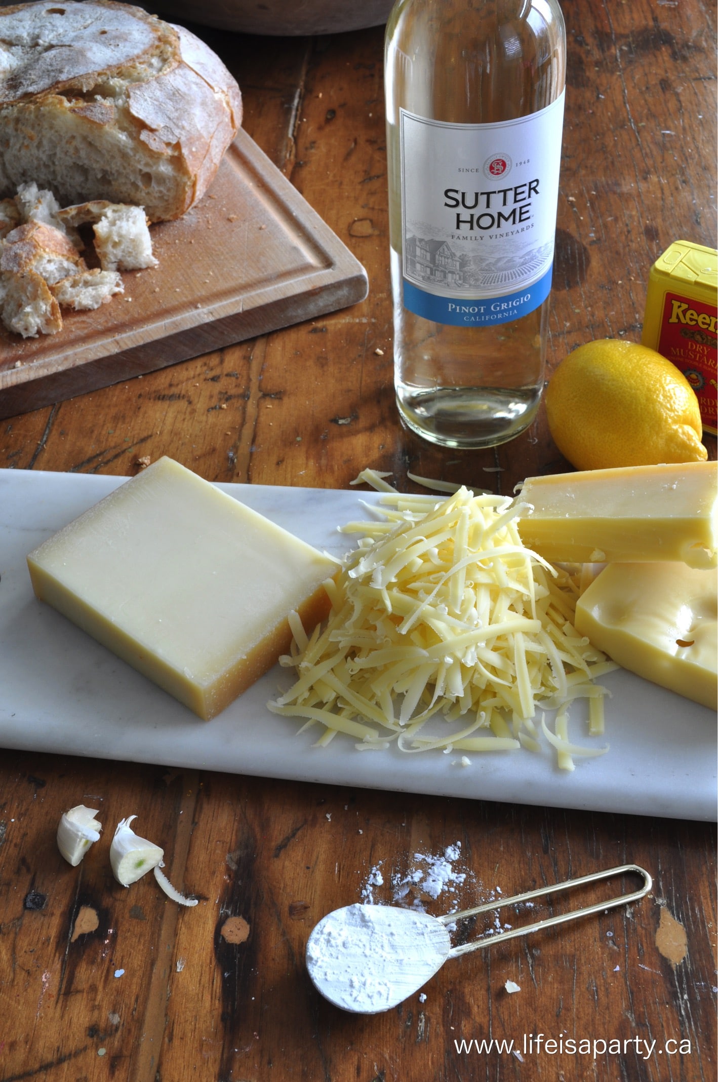 shredded cheese and wine and ingredients for a cheese fondue