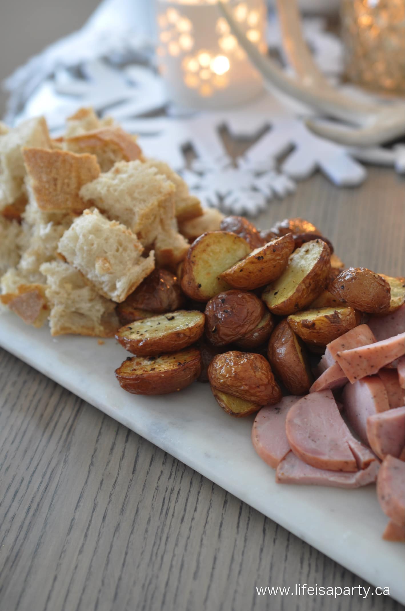Cheese fondue dippers of bread pieces, roasted potatoes and kielbasa sausage.