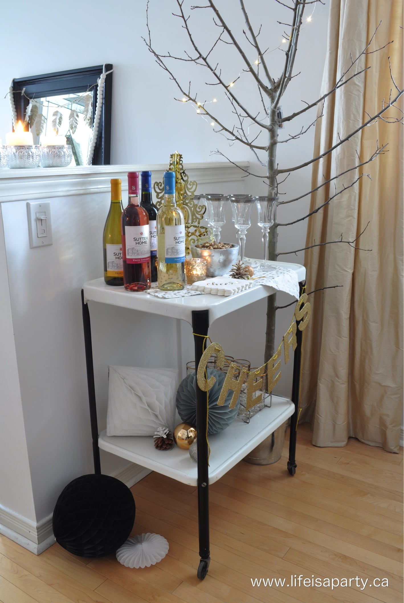 Christmas bar cart set up with wine and wine glasses.