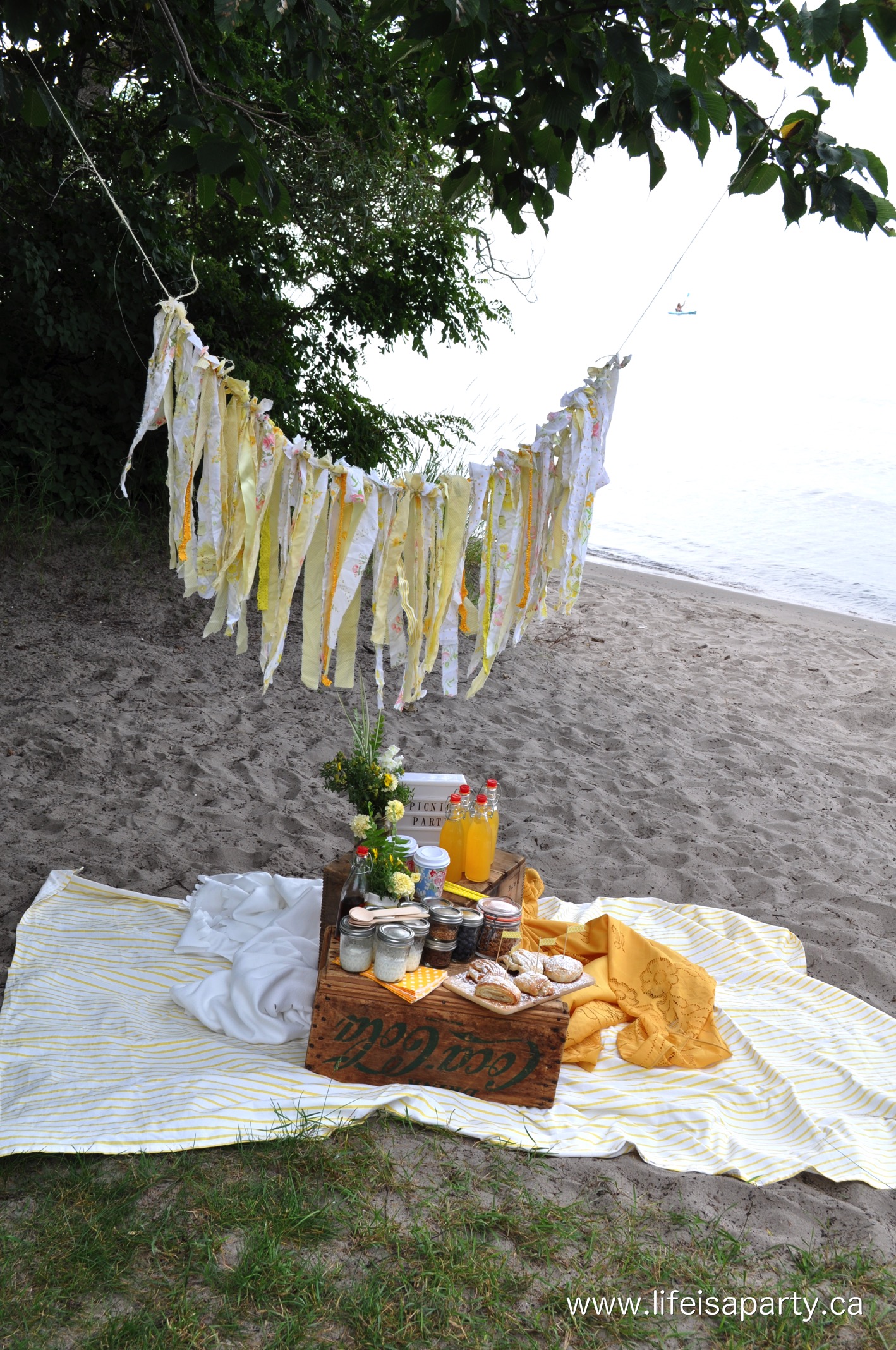 A beautiful breakfast picnic with yellow decor and links to all the recipes including homemade croissants and a yogurt parfait bar!