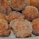Sour cream donut holes rolled in cinnamon sugar.