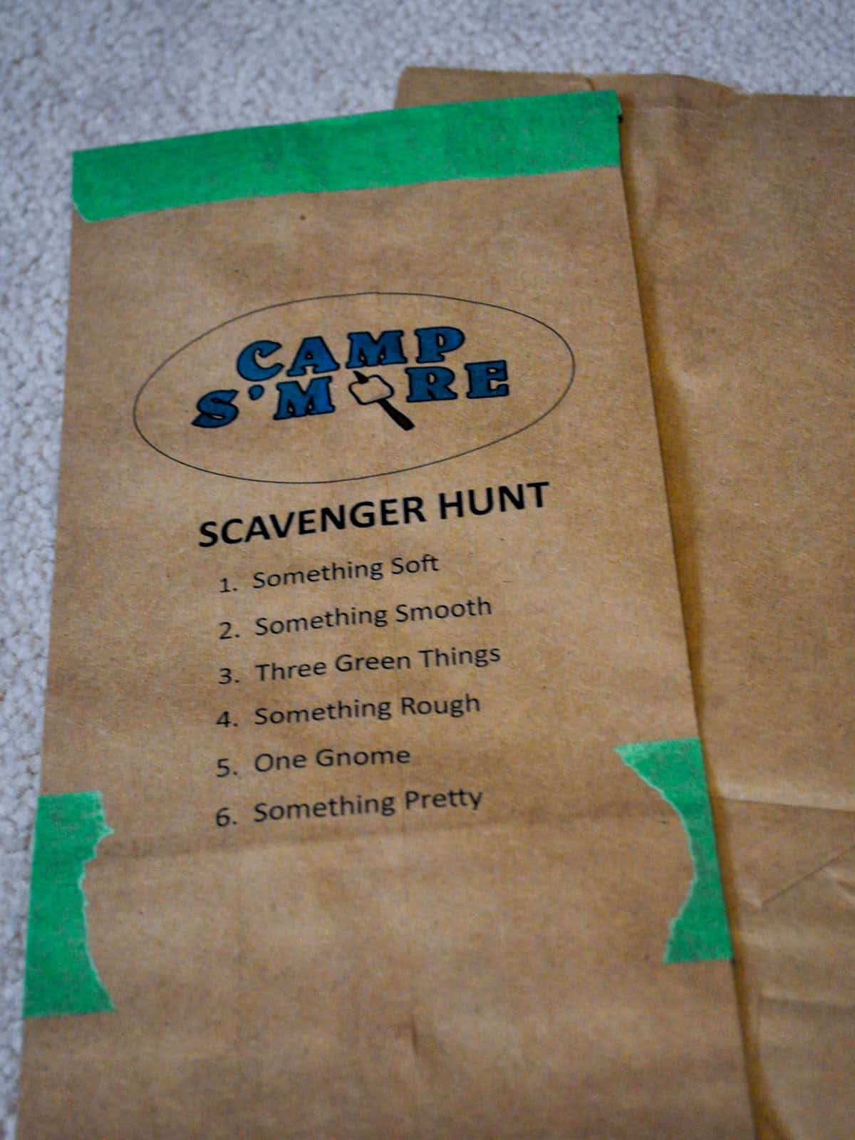 Camp S'more scavenger hunt list printed on a kraft paper bag.