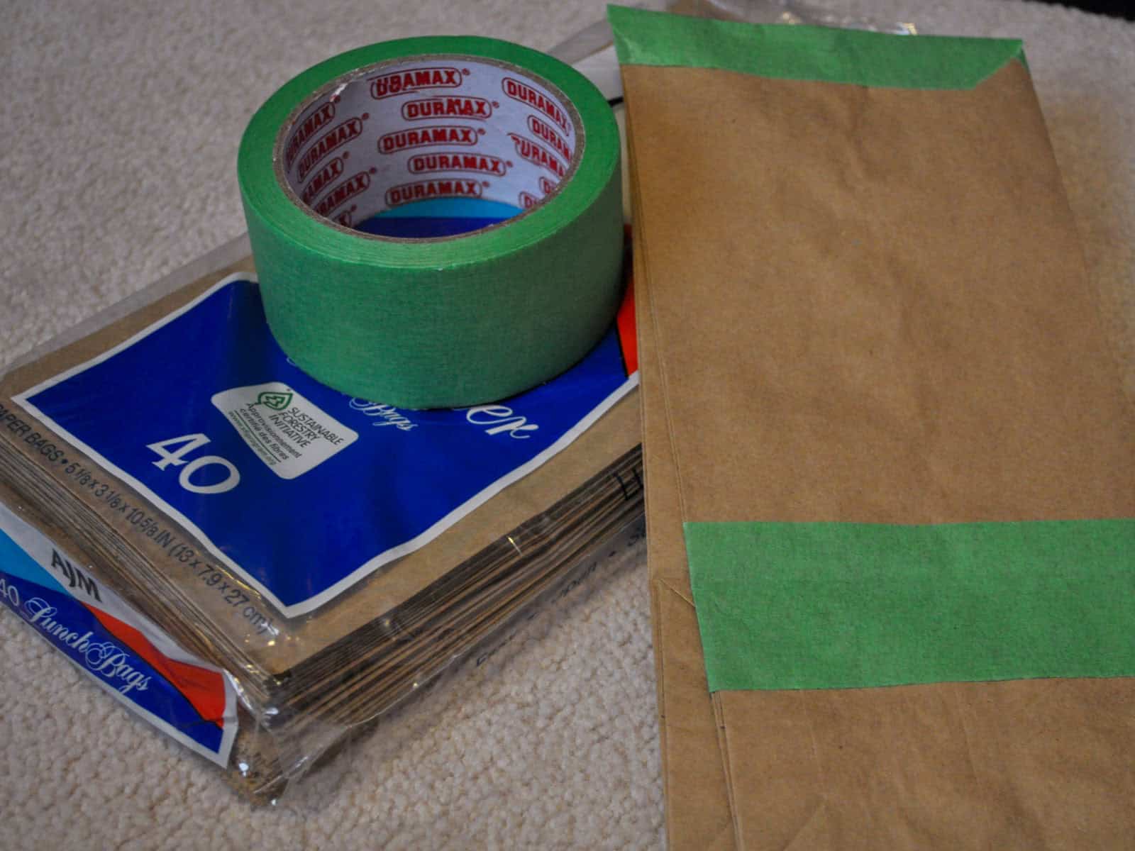 Craft supplies for printing scavenger hunt lists onto paper lunch bags.