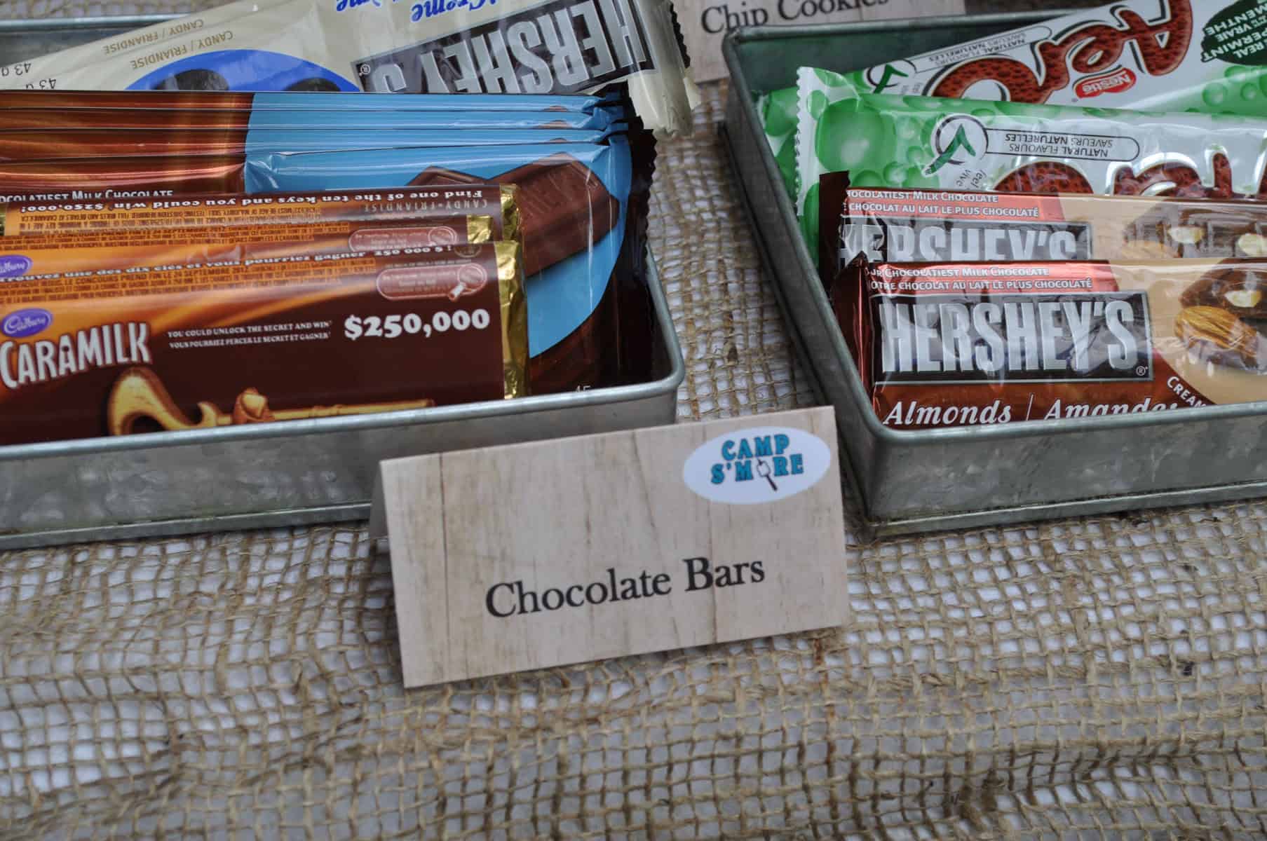Tin of chocolate bars including Caramilk and Hershey's for a build your own s'mores bar.