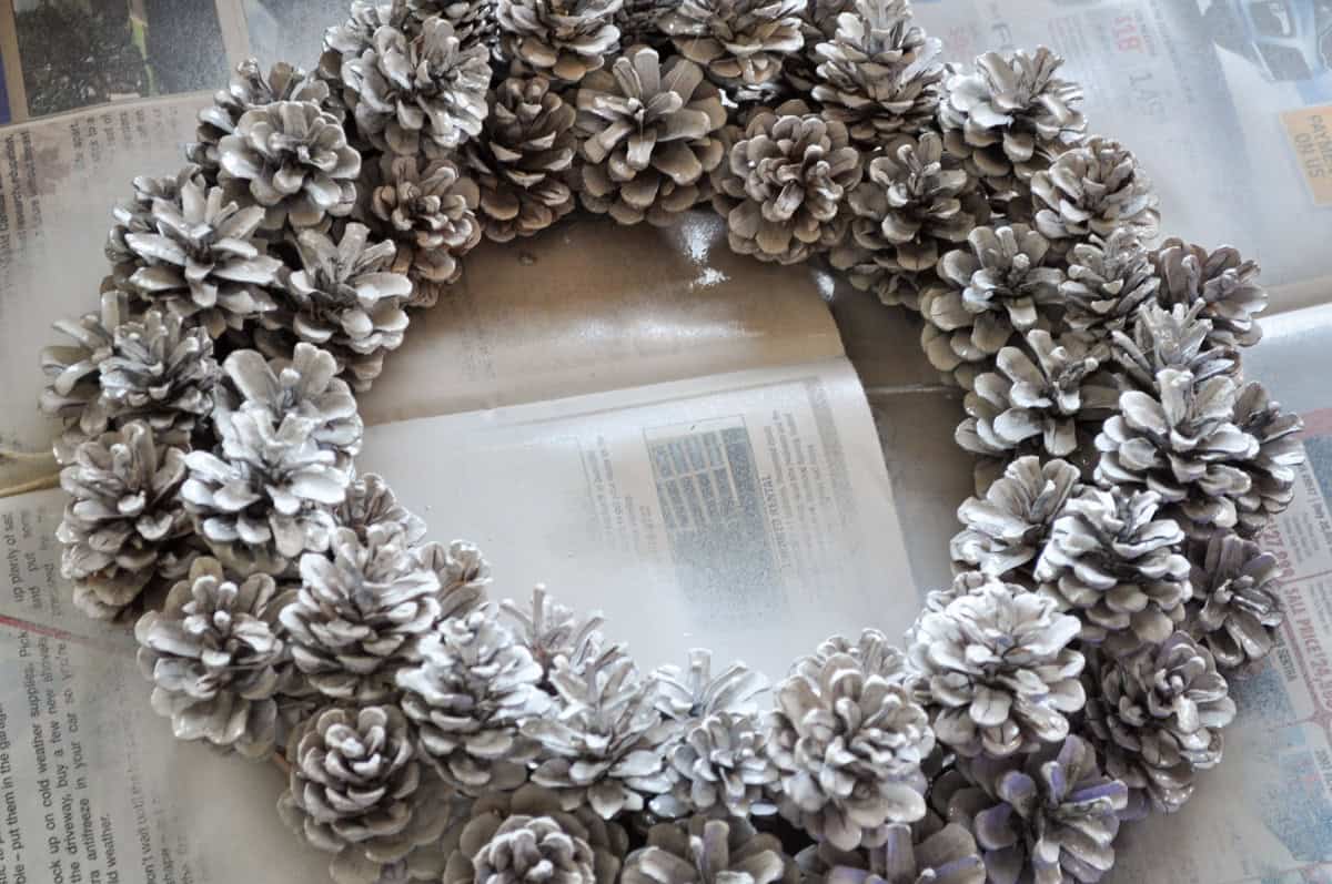 DIY pinecone wreath with one coat of light spray paint on it.