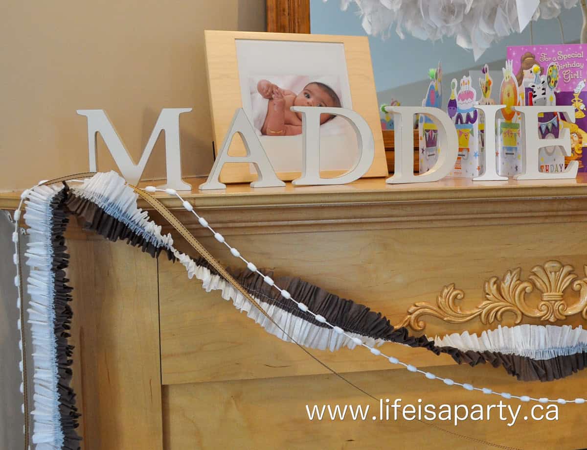 Brown and white ruffled streamer decorations for a chocolate party.