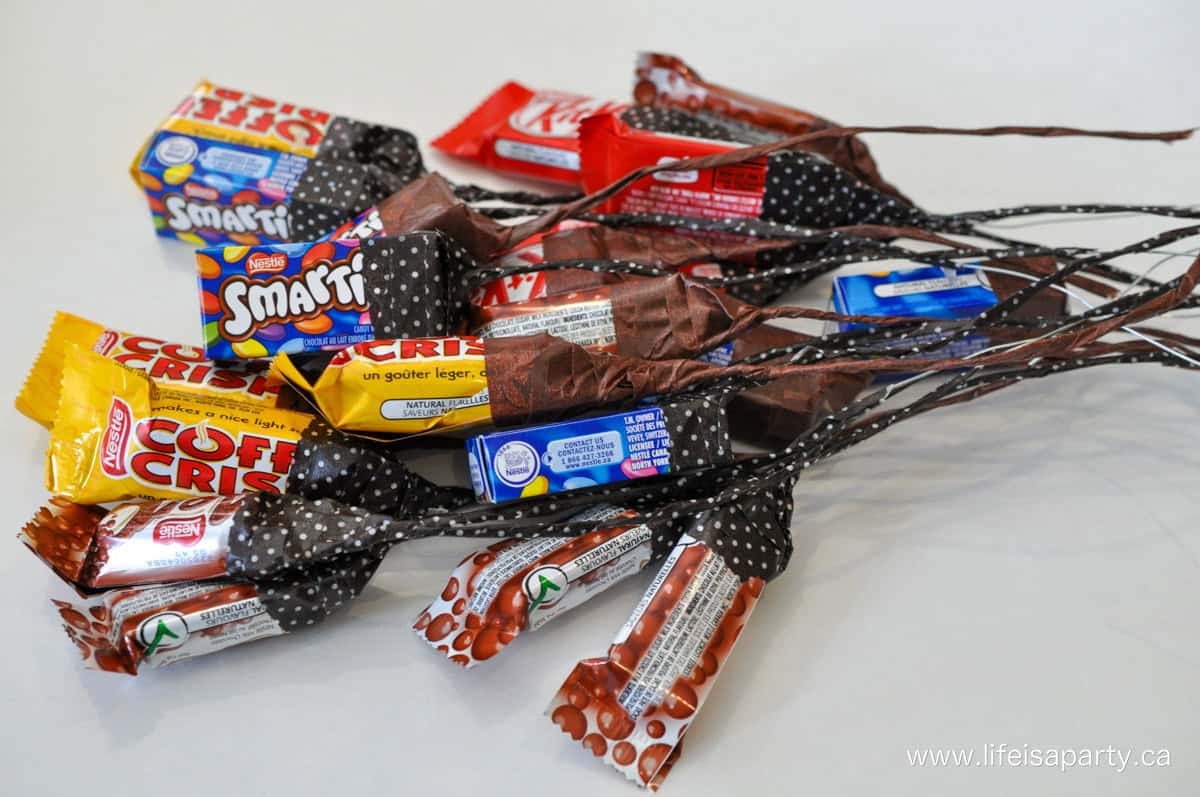 Bouquet of chocolate flowers made from mini chocolate bars, wire, and brown washi tape.
