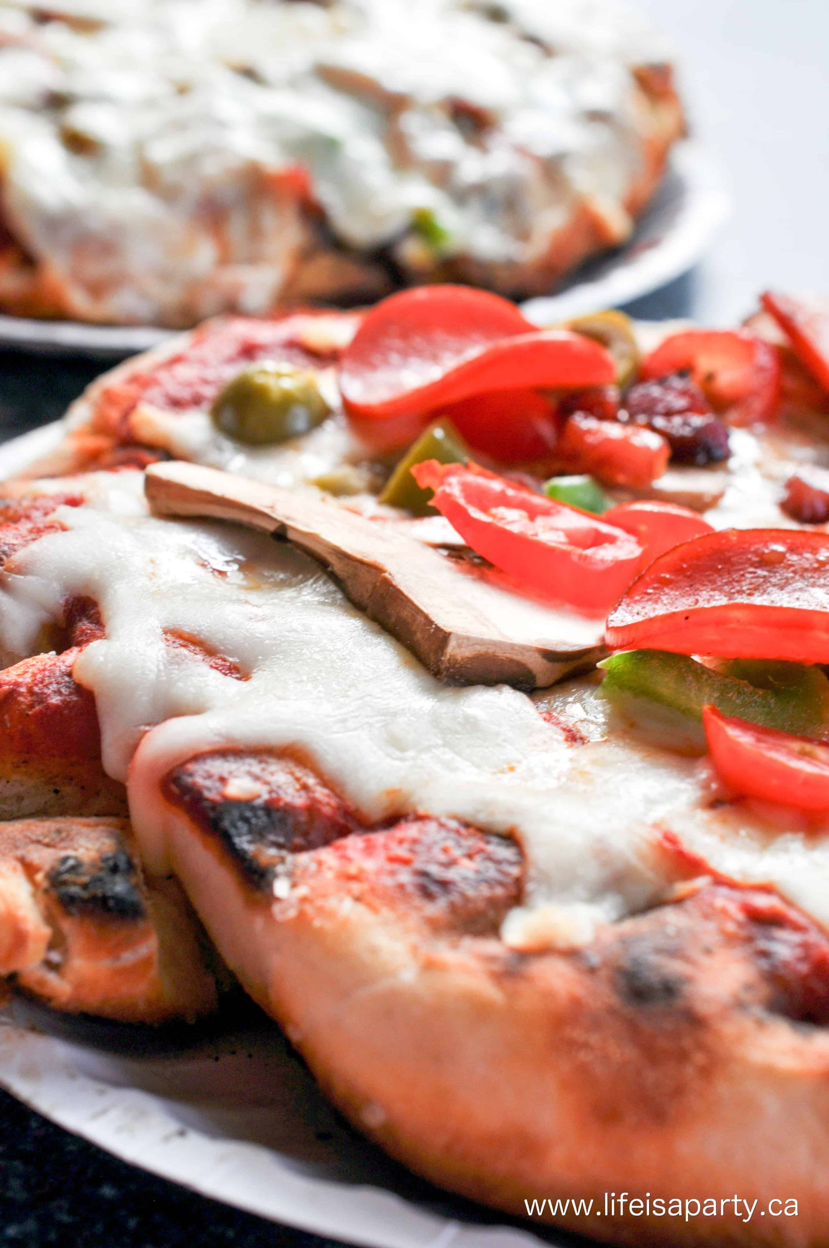 Personal pizzas made on the bbq at a make your own pizza party.