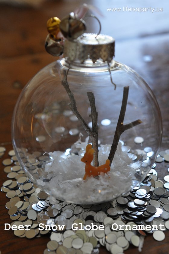 Deer Snow Globe Christmas Ornament -DIY your own cute deer snow globe, with a glass or plastic ornament, and a few other inexpensive supplies.