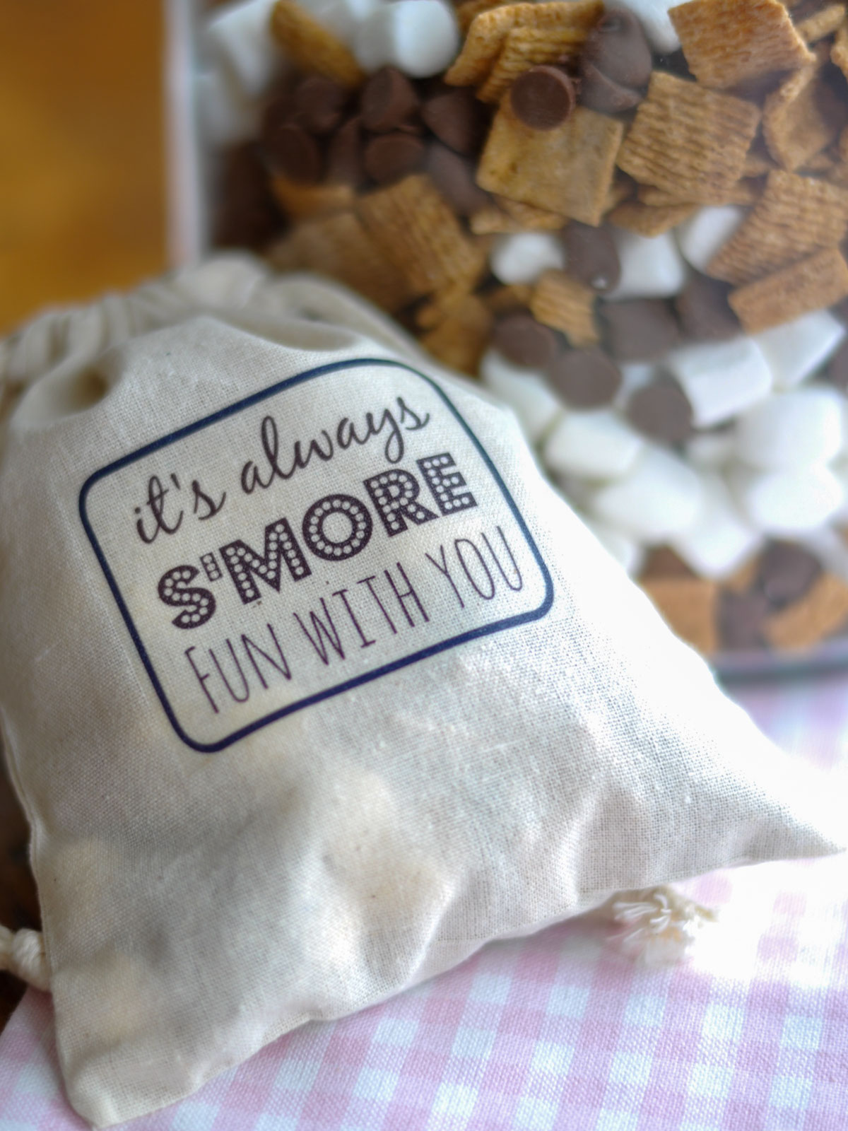 Canvas gift bag printed with a s'mores label filled with trail mix.