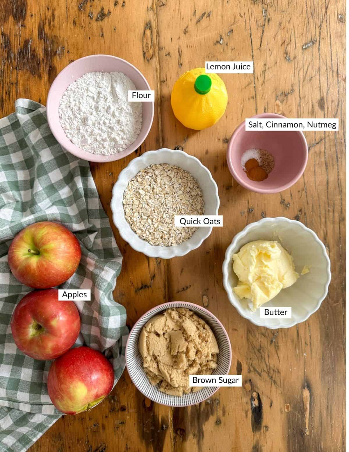 Mini apple crisp ingredients in bowls on a table.