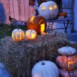 DIY Fairy pumpkin house village lit up with candles at night.