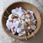 Wooden bowl full of homemade 3D origami hearts.