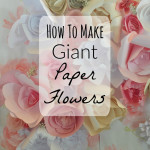 Giant paper flowers in pinks and whites used as a big wall backdrop.