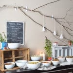 Pasta bar for a party with different pastas, sauces, and toppings.