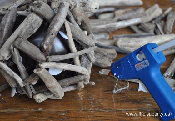 Making DIY wood pumpkins with drift wood, balloons and glue gun.
