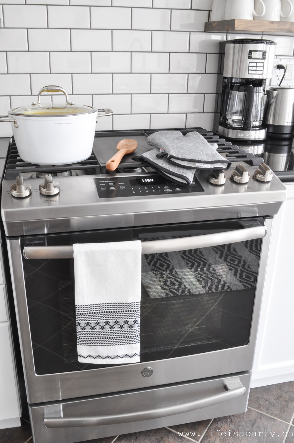 stainless steal stove and white subway tile