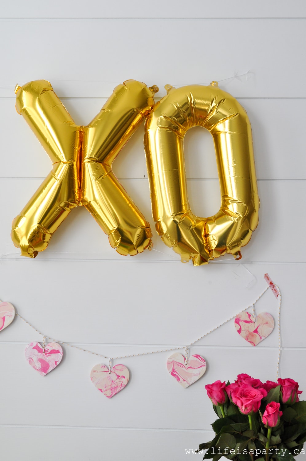 Galentine's Day XO balloons, heart garland and pink roses