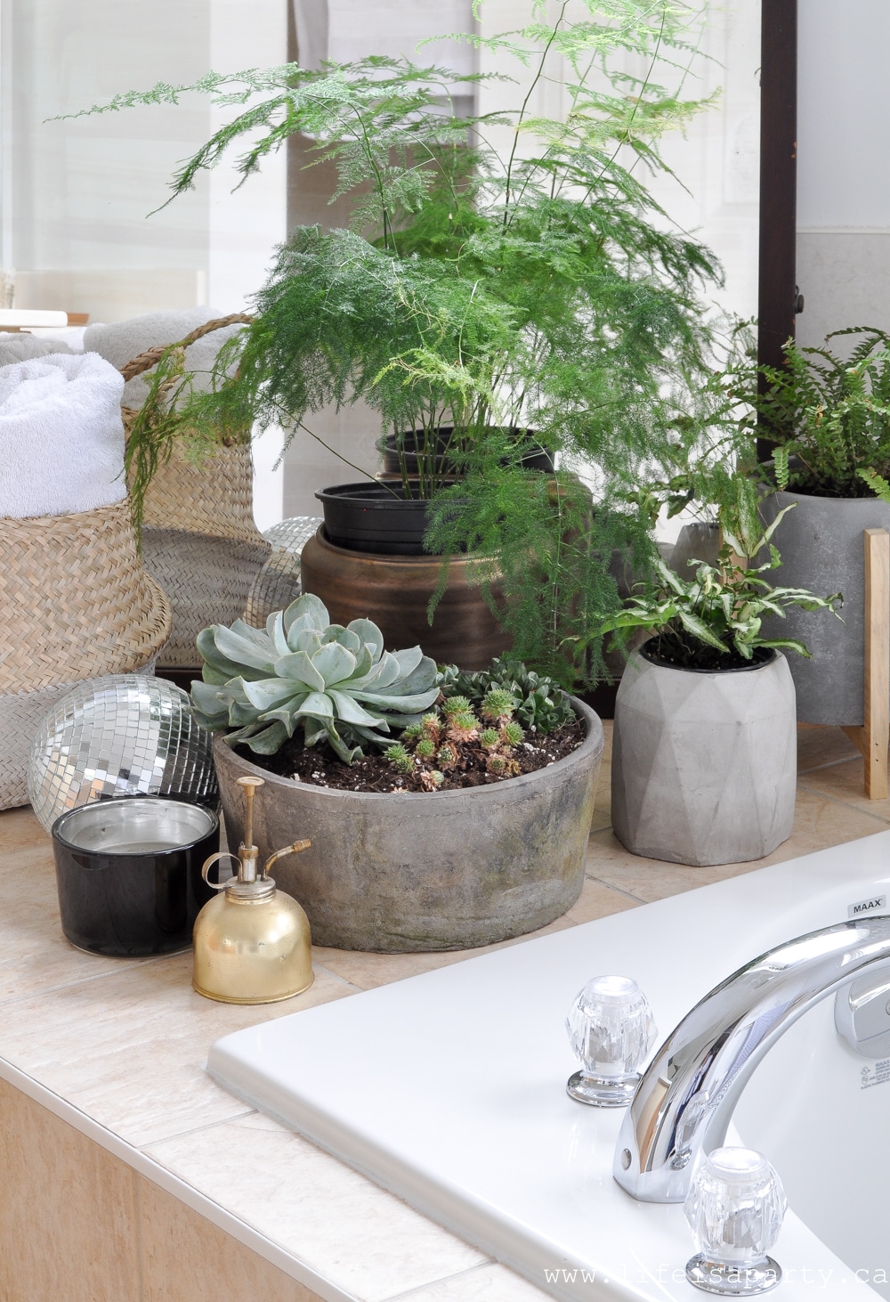 Modern Boho Bathroom Refresh -fresh white paint, a DIY tub tray, beads, candles, and lots and lots of plants turned this bathroom from boring to boho in just a few days.