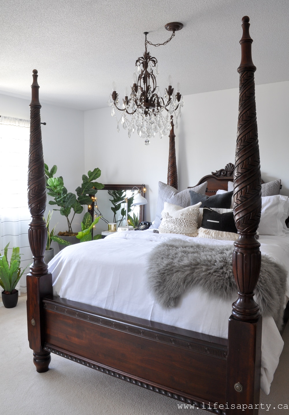 Modern Boho Bedroom: Black and white, woven wall hangings, a modern gallery wall, lots of plants, boho string lights, and tons of textured pillows give this room its European Modern Bohemian vibe.