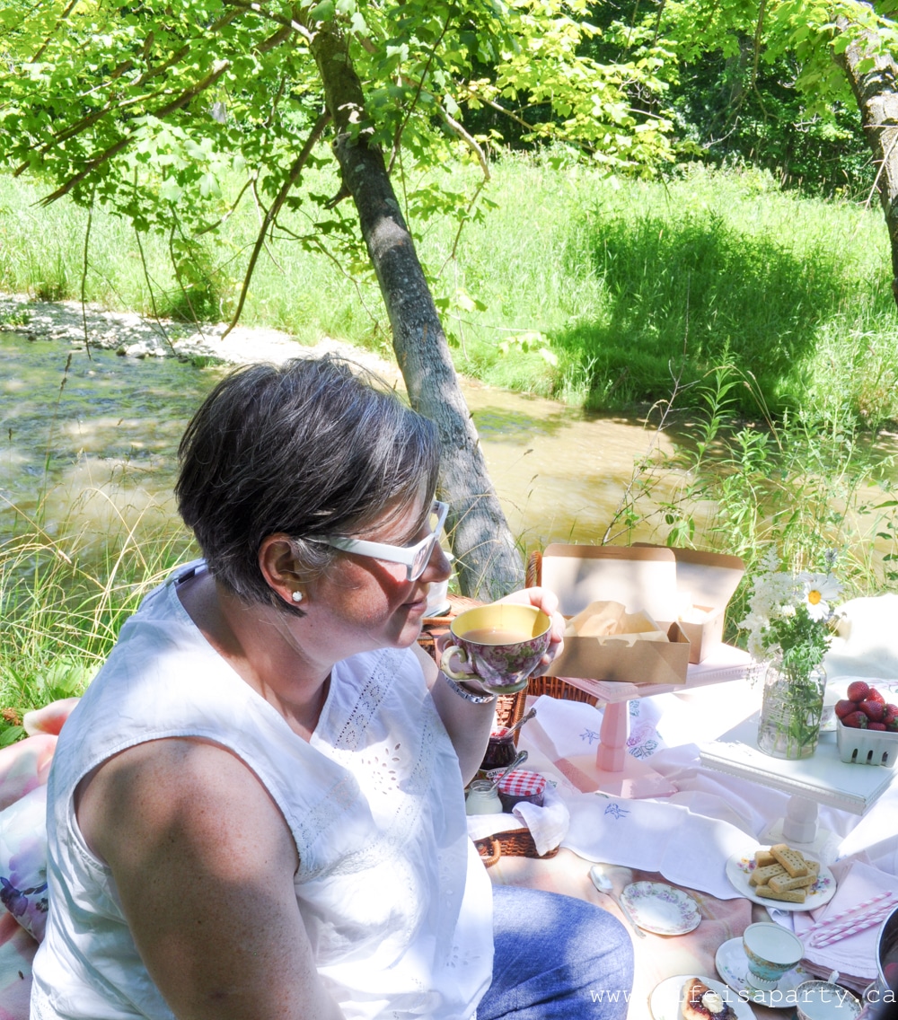 British inspired picnic tea party beside a river