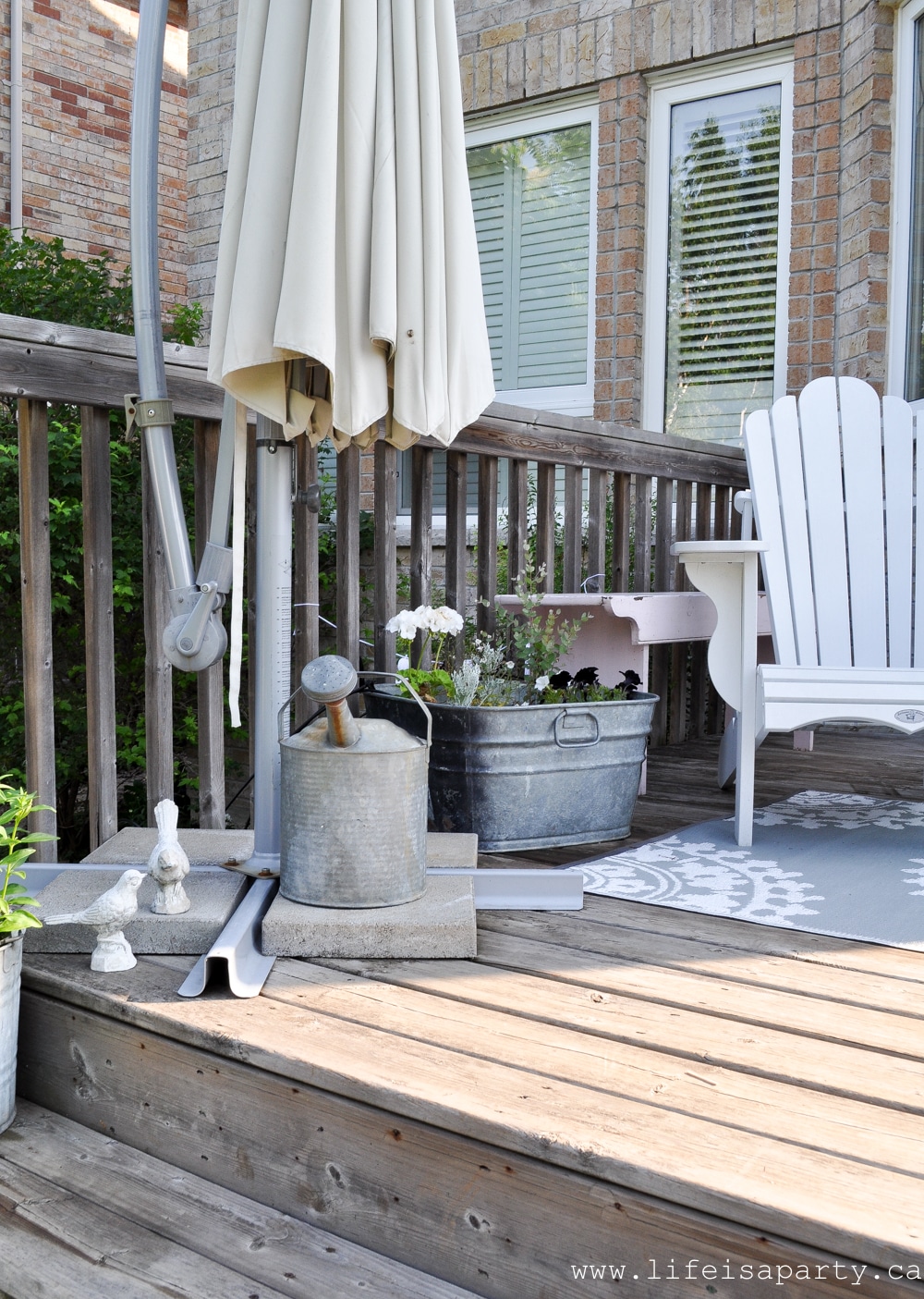 deck with Black and White container Gardens in vintage metal tubs and pails