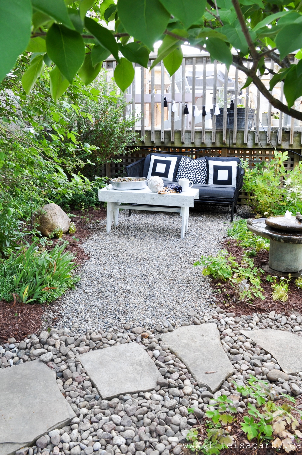 pea gravel seating area in a small garden