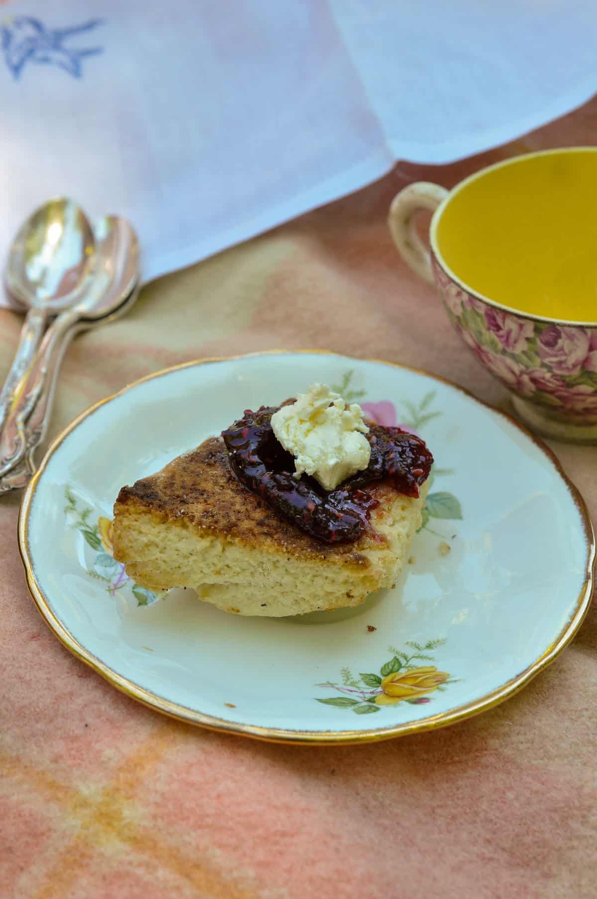 Scone with jam and clotted cream, part of a tea party picnic menu.