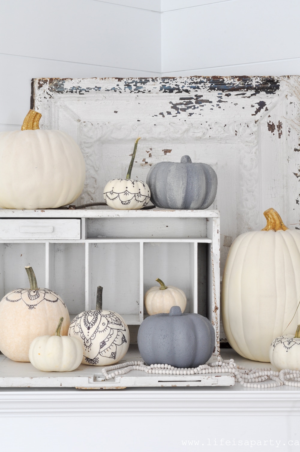 neutral fall mantel with white and concrete pumpkins