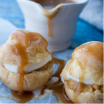Pumpkin Cream Puffs: A cream puff filled with pumpkin pastry cream, whipped cream, and topped with warm caramel sauce for the perfect fall dessert.