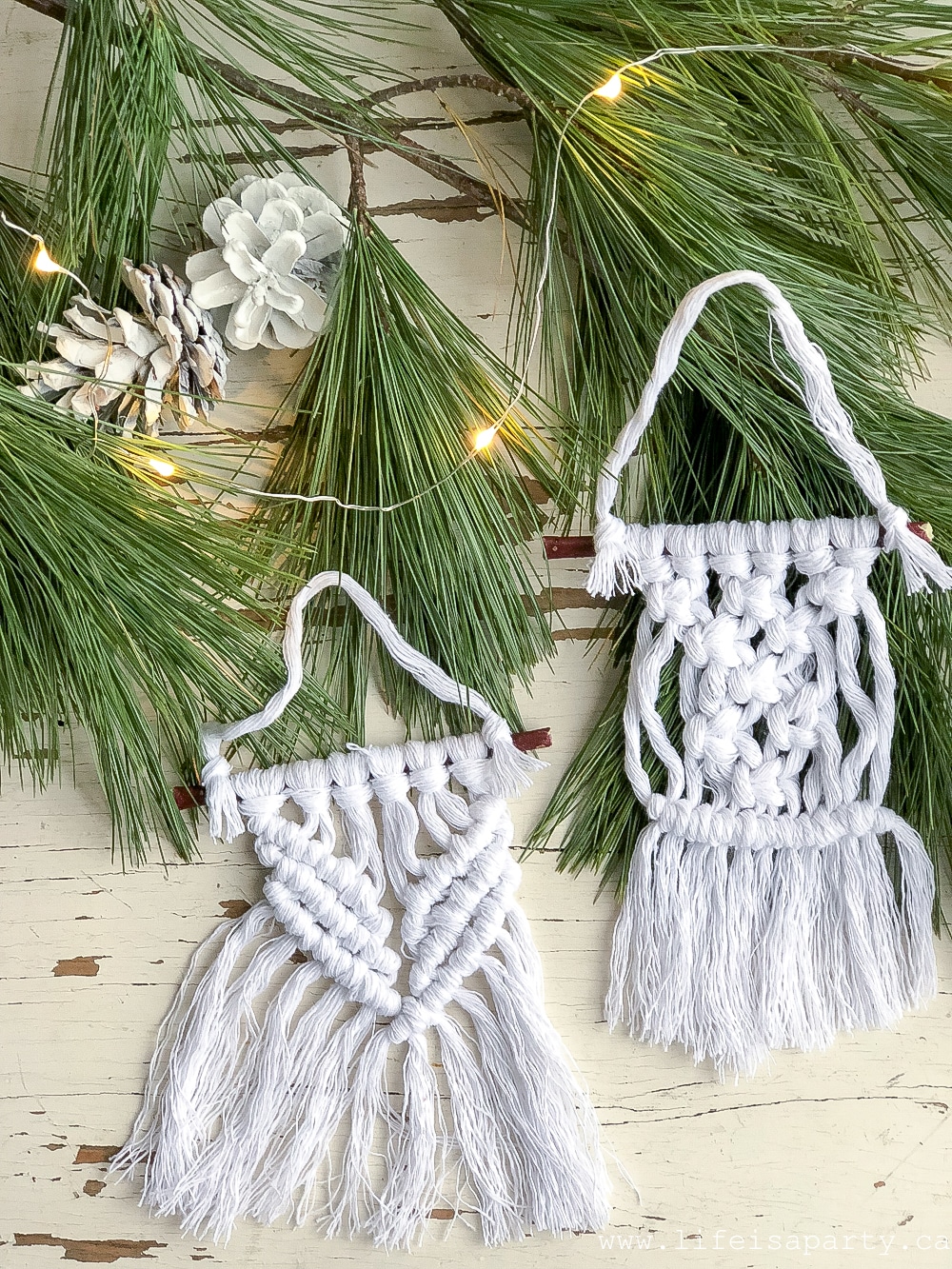 Two different Christmas macrame ornaments with some twinkle lights and fresh greens.