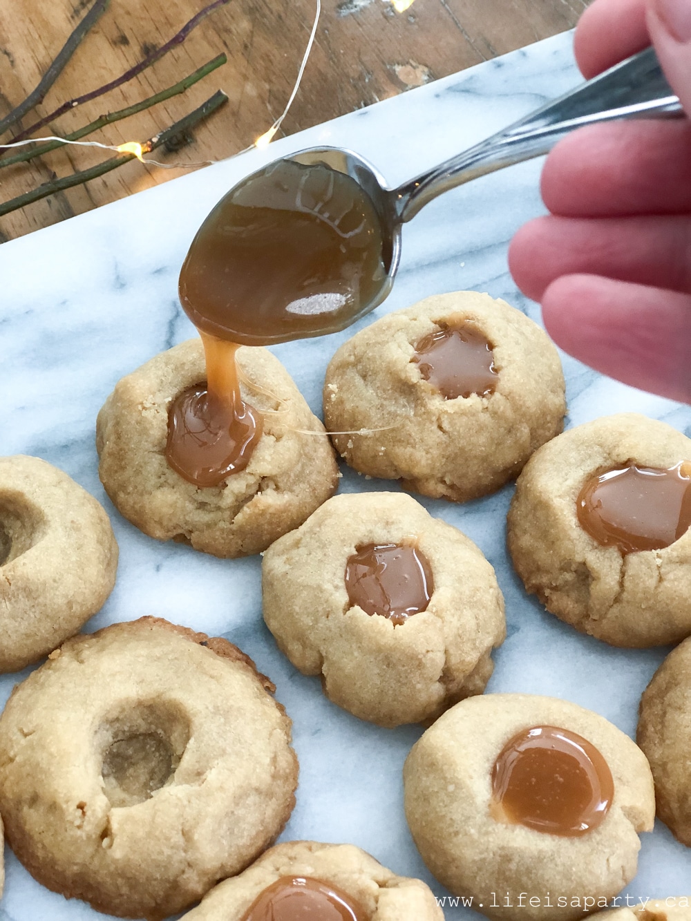 adding caramel to Brown Sugar Shortbread cookies