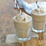 Homemade iced capps in glasses on a wood table.